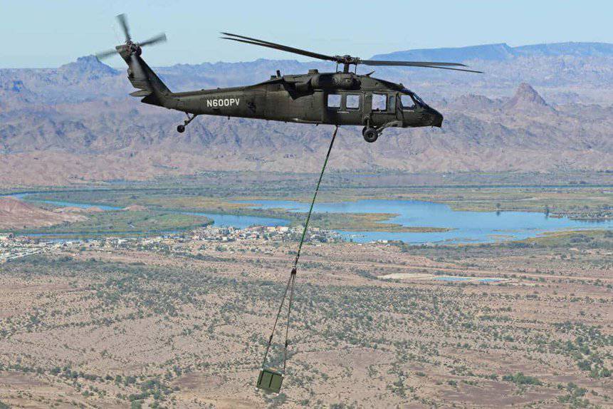 Pilotless Sikorsky S-70 UH-60 Black Hawk helicopter demonstrates external cargo transport.