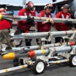 United States sailors carrying AIM-9X Sidewinder missiles. Photo: US Navy.